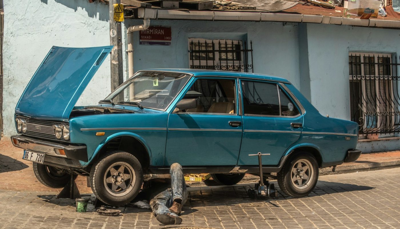 a blue car parked in front of a blue building