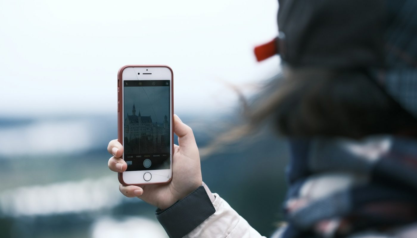 a person taking a picture with a cell phone