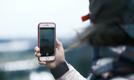 a person taking a picture with a cell phone